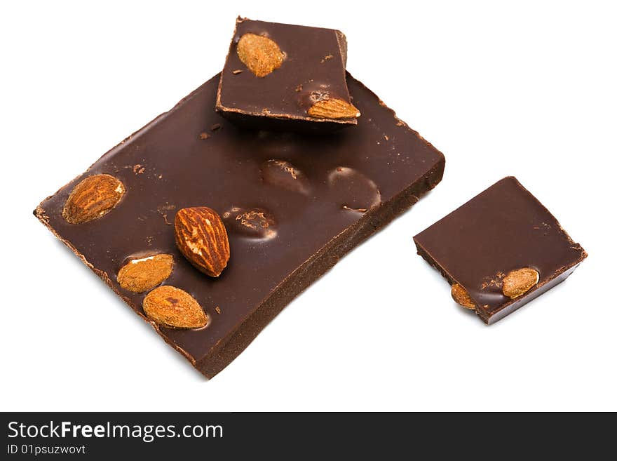 Dark chocolate with nuts on white background