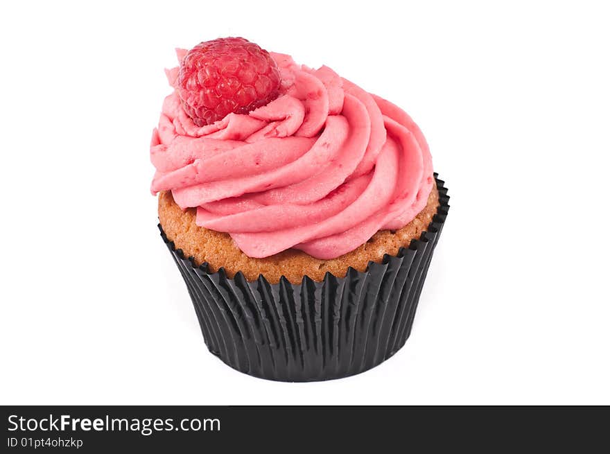 A lovely looking cupcake, with a raspberry on top, isolated on a white background. A lovely looking cupcake, with a raspberry on top, isolated on a white background