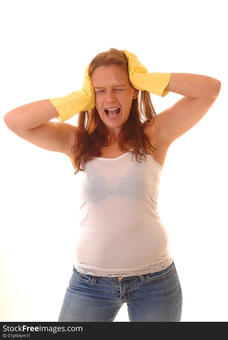 A screaming woman holding her hands, in yellow rubber cloves, against her head, in an white t-shirt and jeans with long brown hair. A screaming woman holding her hands, in yellow rubber cloves, against her head, in an white t-shirt and jeans with long brown hair.