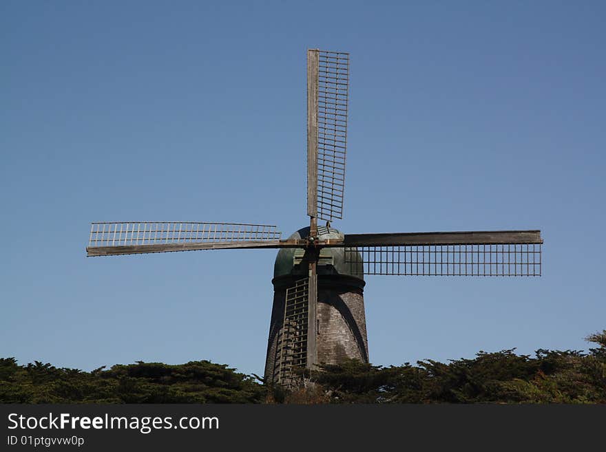 Windmill rising above the wood line