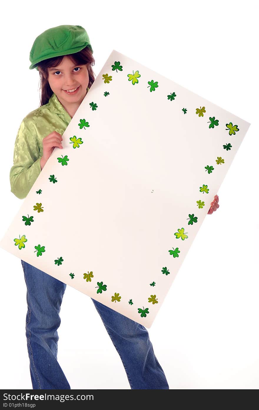 A shamrock-bordered sign left blank for your message. Sign is being held by a happy elementary girl dressed in green. Isolated on white. A shamrock-bordered sign left blank for your message. Sign is being held by a happy elementary girl dressed in green. Isolated on white.