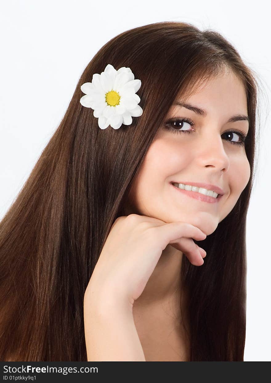 Portrait of a pretty young  girl with a flower in her hair. Portrait of a pretty young  girl with a flower in her hair