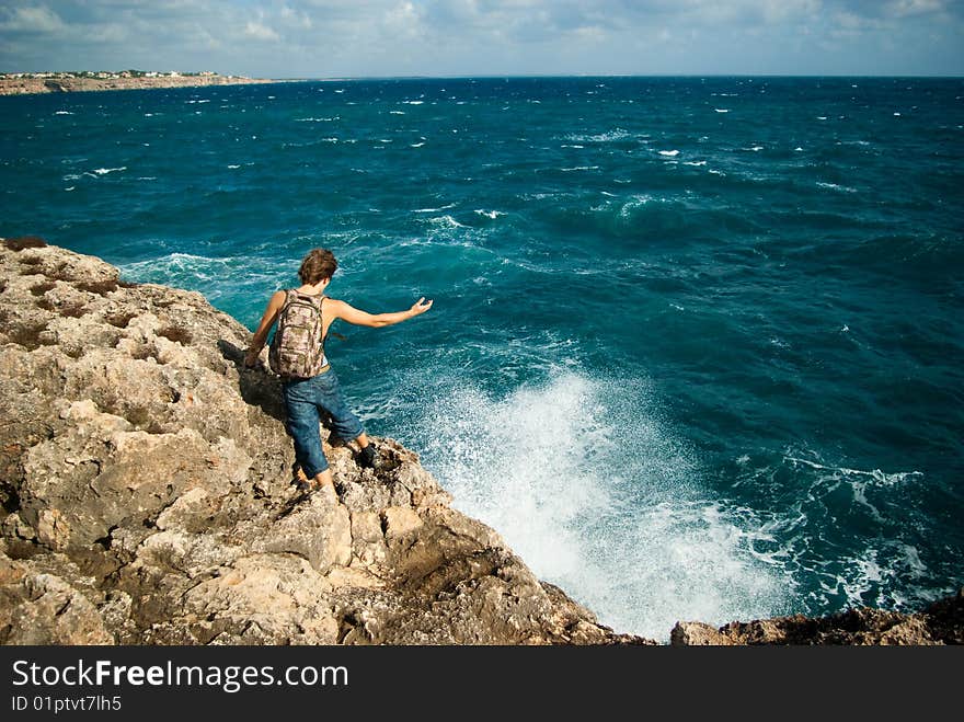 Man holds out a hand to the sea