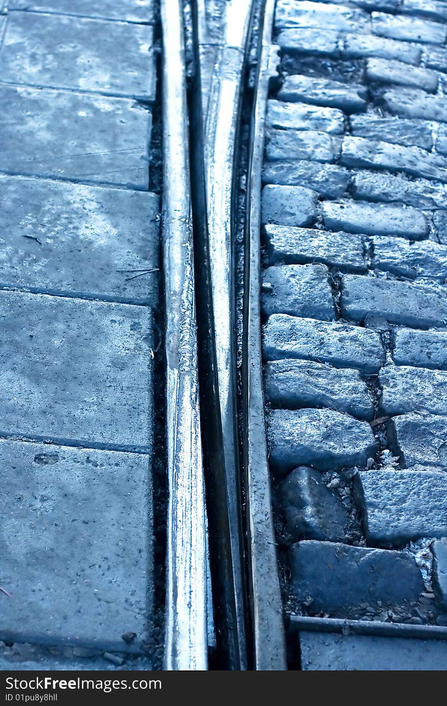 A closeup of a tram rail switch with city pavement. A closeup of a tram rail switch with city pavement