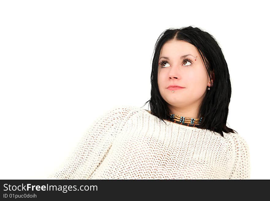 Portrait of teenage girl with face piercings looking up, studio shot