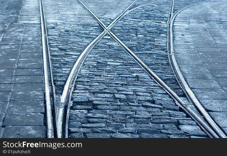 A closeup of a tram rail switch with city pavement. A closeup of a tram rail switch with city pavement