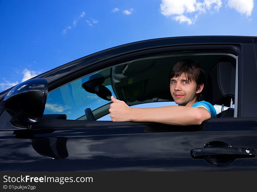 Successful young man sitting in own car