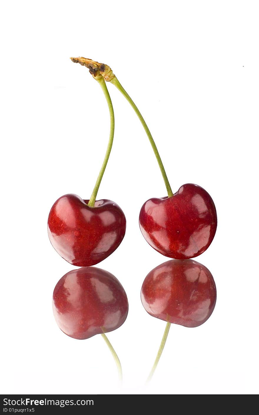 A pair of cherry on a mirror with white background