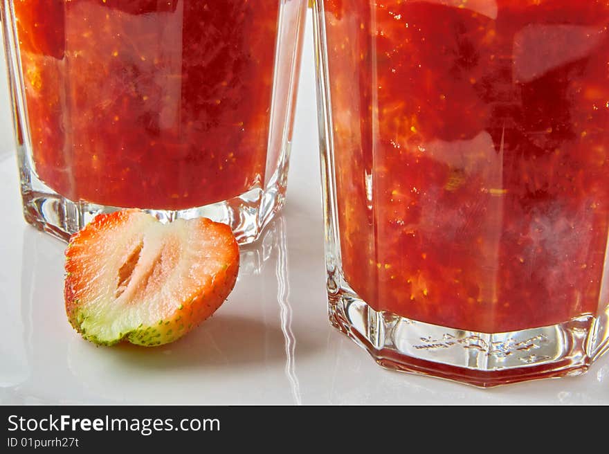 Glass of Strawberry Jam and sliced Fruit