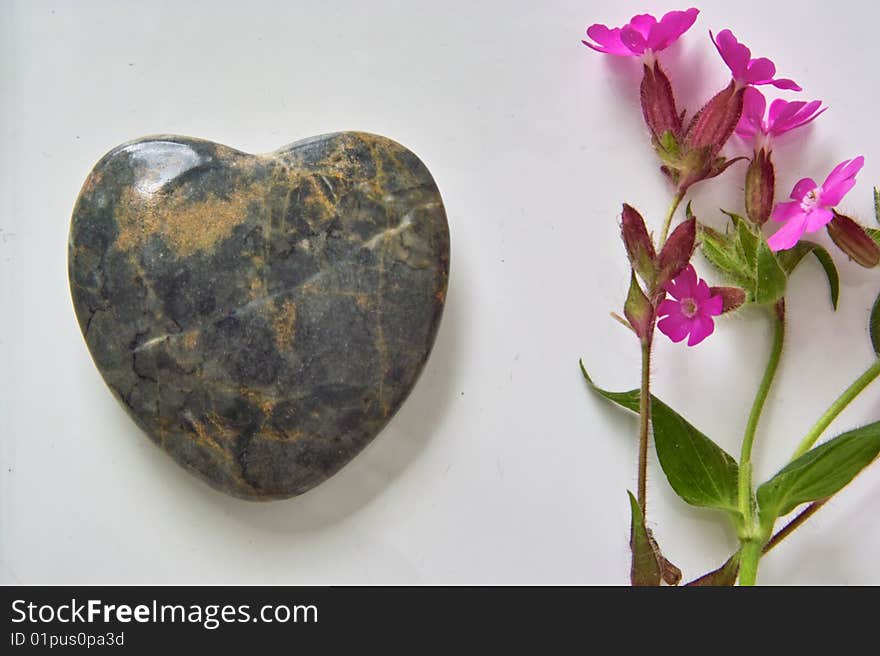 Heart made out of Stone with pink Flower. Heart made out of Stone with pink Flower