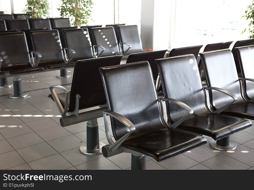 Some leather chairs at an airport gate. Some leather chairs at an airport gate