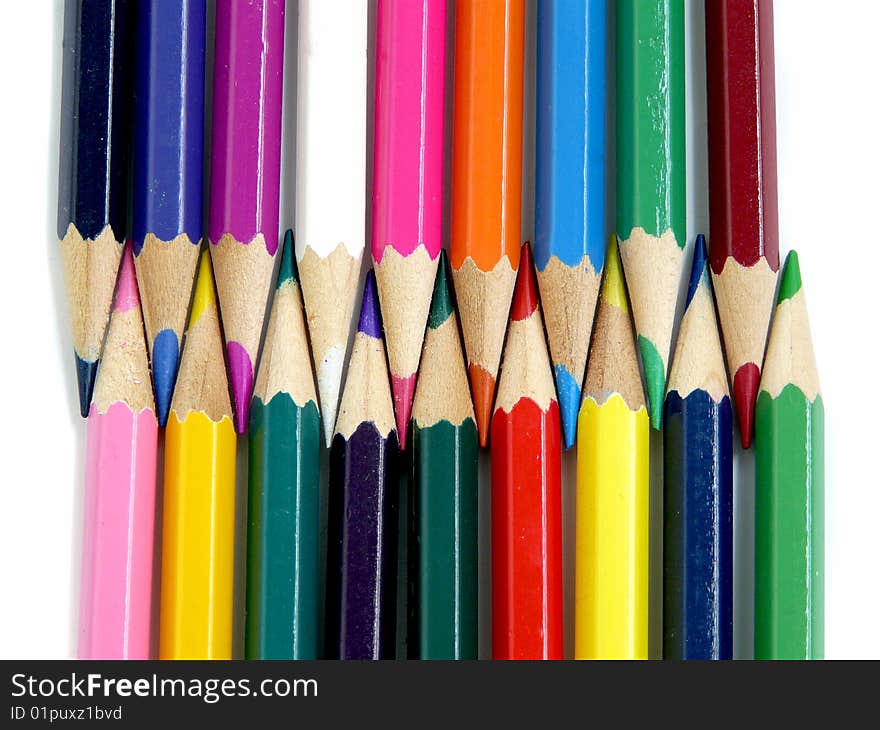 Two rows of multicolored pencils, isolated over white