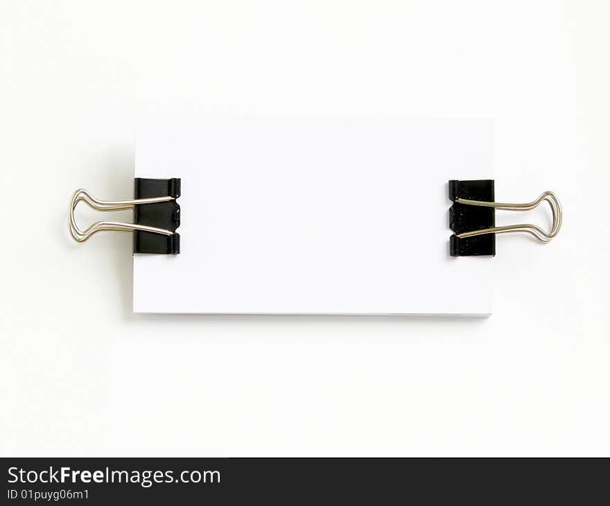 Block of white cards attached with paperclips, isolated over white