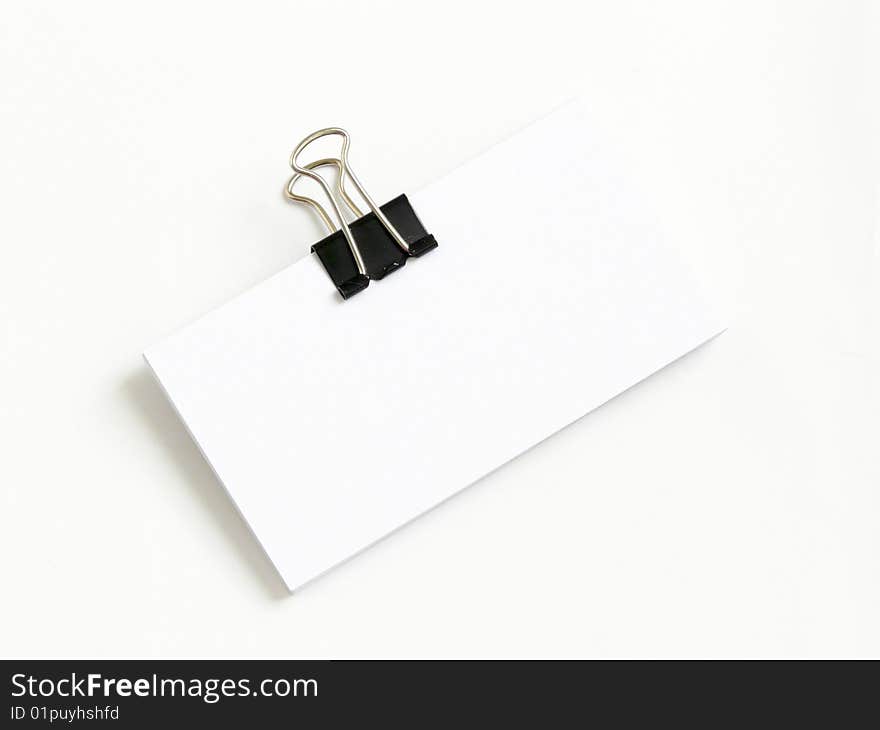 Block of white cards attached with paperclips, isolated over white