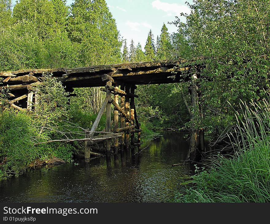 Russia, Sougth Karelia, wooden bridge on the road through the forest. Russia, Sougth Karelia, wooden bridge on the road through the forest.