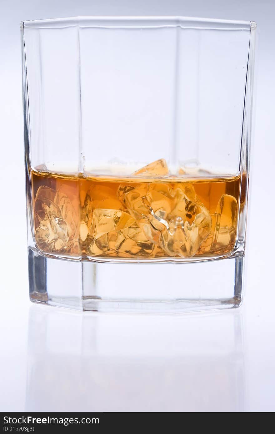 A glass of whiskey with ice