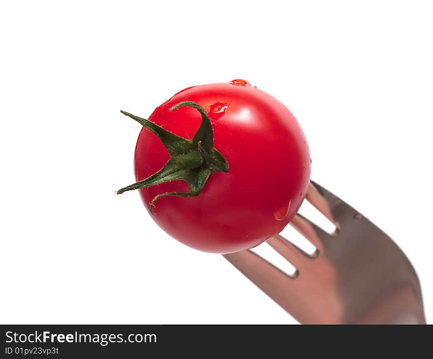 Cherry tomato on the fork isolated