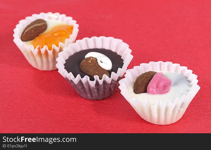 Chocolate candies in the white paper rosettes. Chocolate candies in the white paper rosettes