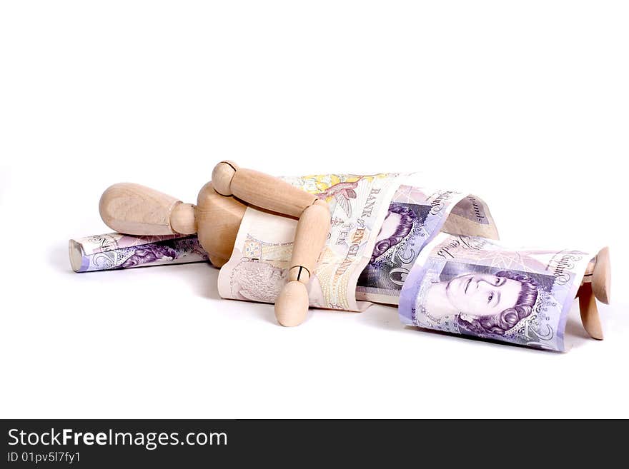 A mannequin sleeping under ten and twenty pound notes. A mannequin sleeping under ten and twenty pound notes.