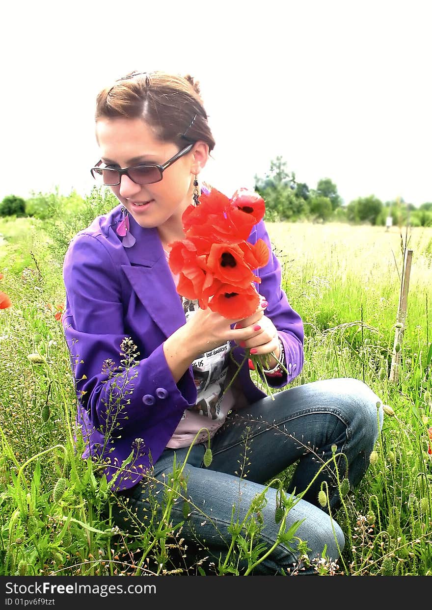 Young girl among red poppies on the meadow. Young girl among red poppies on the meadow