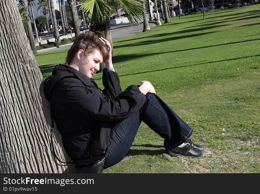 The young woman rests after a long walk. The young woman rests after a long walk