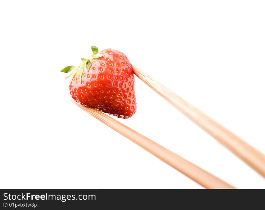 Strawberry close-up held with chop sticks