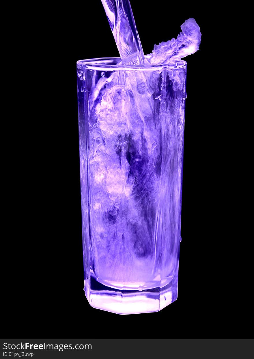 The glass in which water is poured, is illuminated by violet light. The glass in which water is poured, is illuminated by violet light