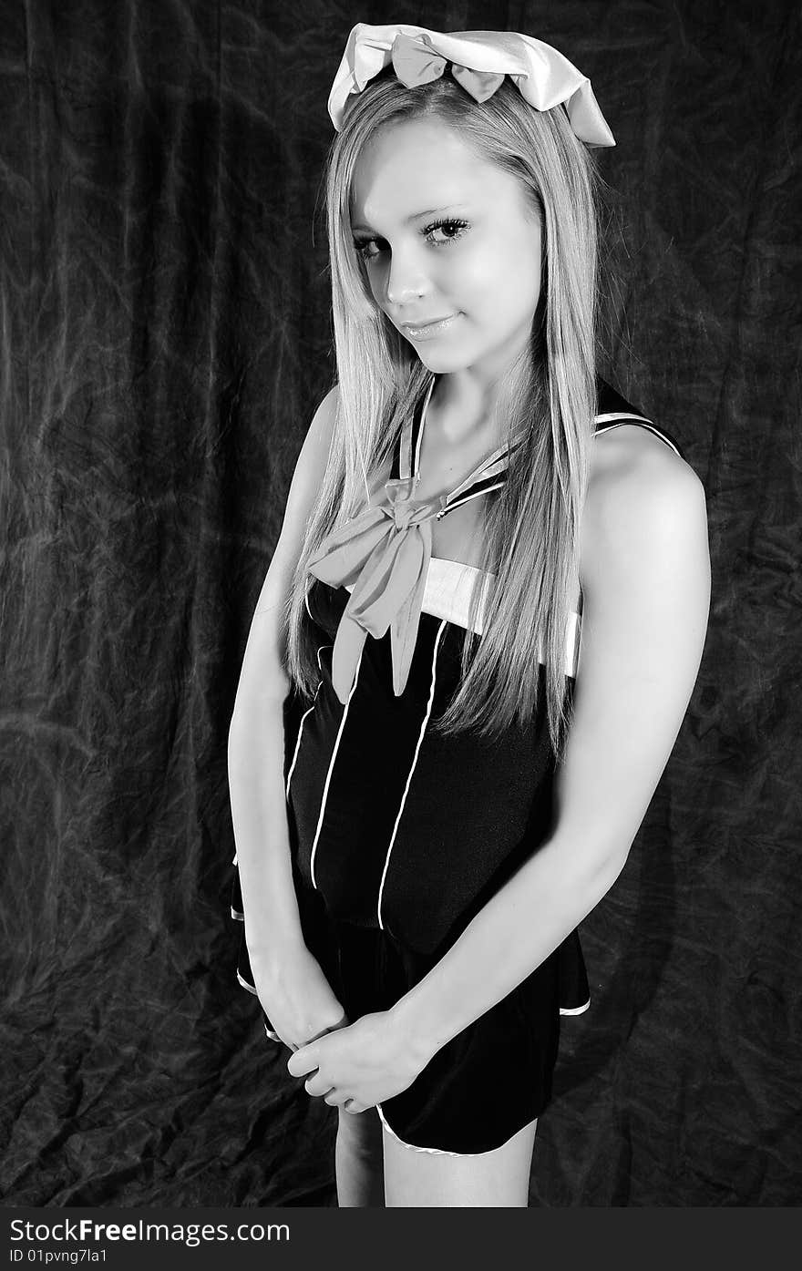 Young female fashion model looking innocently at the camera wearing a sailor outfit altered to black and white to show the clear complexion of her skin. Young female fashion model looking innocently at the camera wearing a sailor outfit altered to black and white to show the clear complexion of her skin.