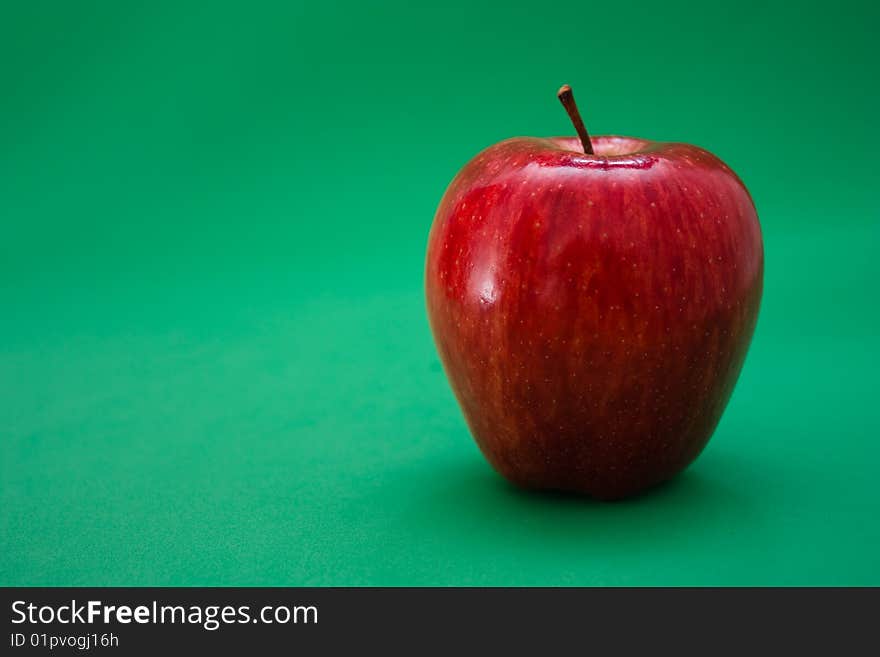 Red apple on a green background