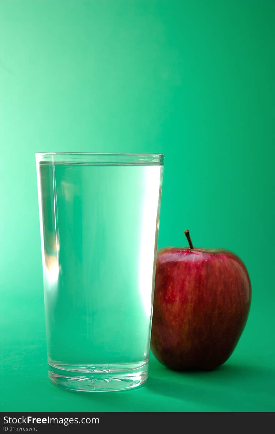 Glass of water and red apple. Glass of water and red apple