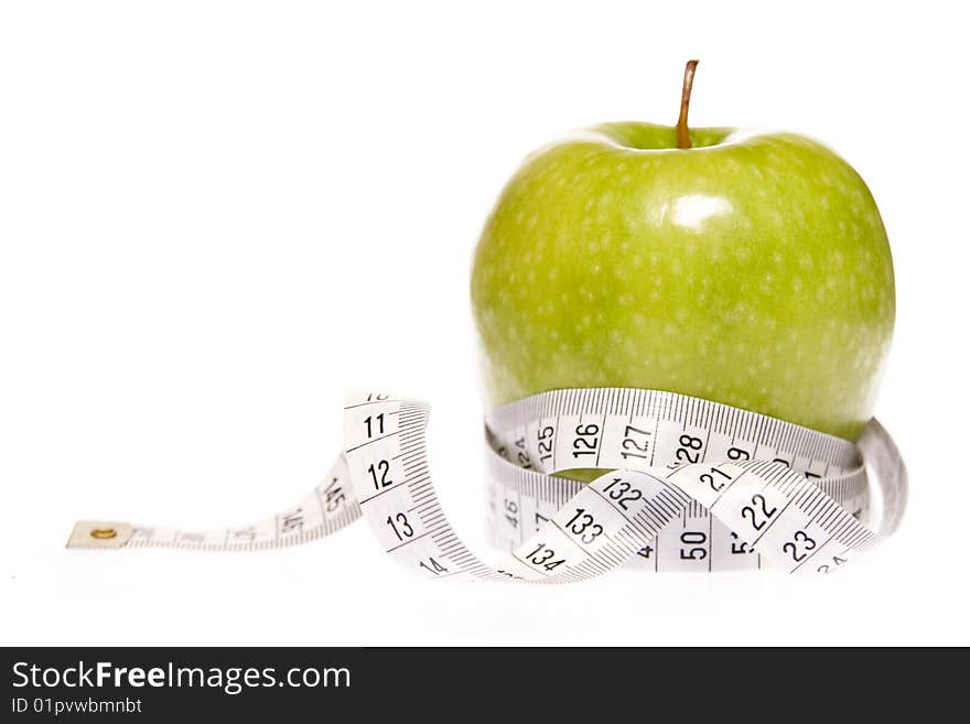 Apple entangled in measuring tape. Apple entangled in measuring tape