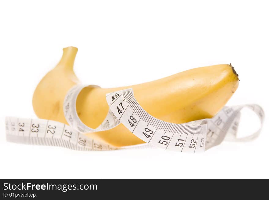 Banana entangled in measuring tape. Banana entangled in measuring tape