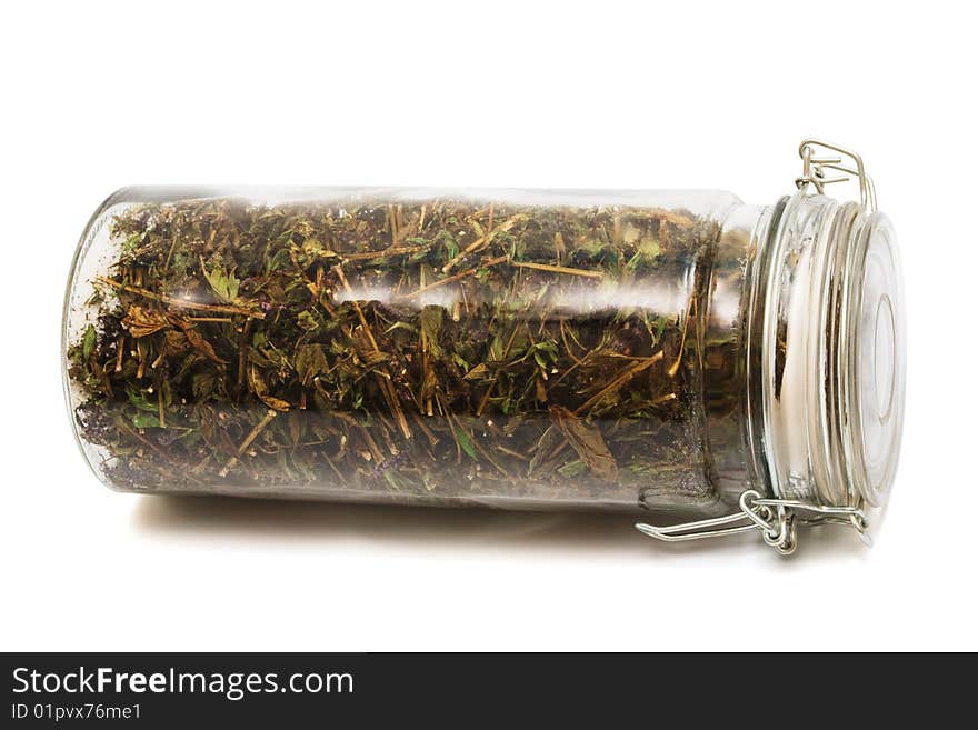 Herbs in a jar on a white background