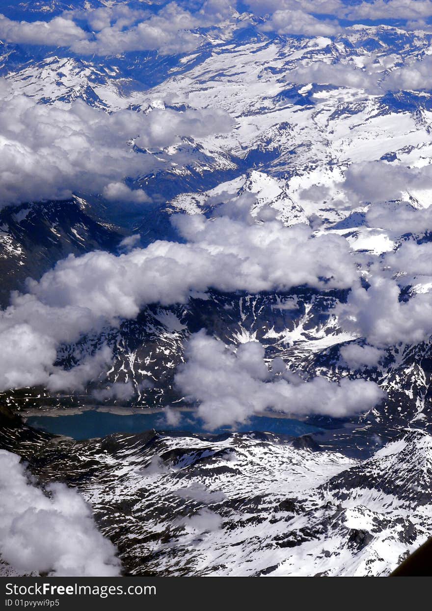 Blue sky with white clouds over lake and mountains,Alps, France. Blue sky with white clouds over lake and mountains,Alps, France.