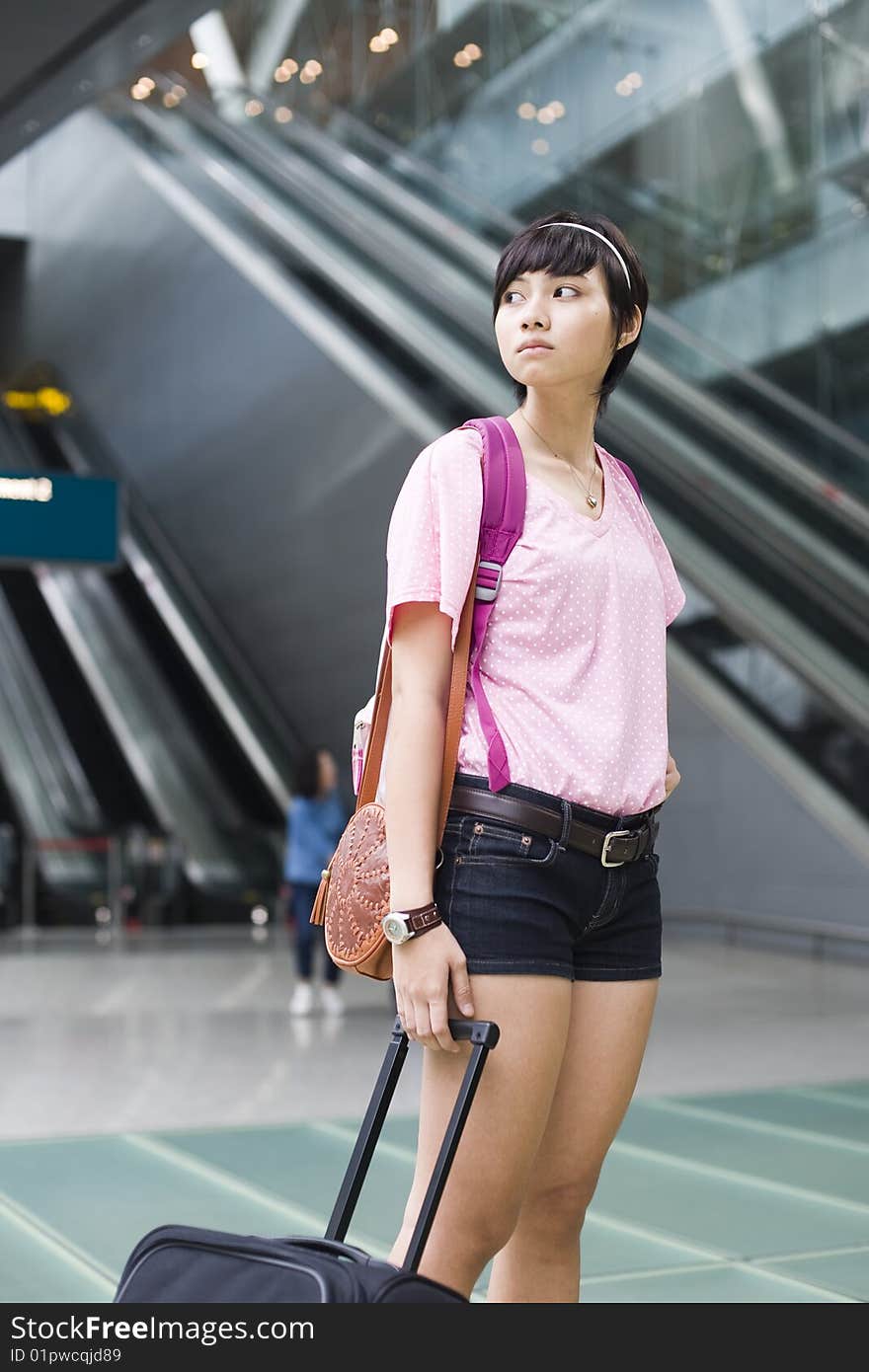 An asian girl at singapore's changi airport terminal