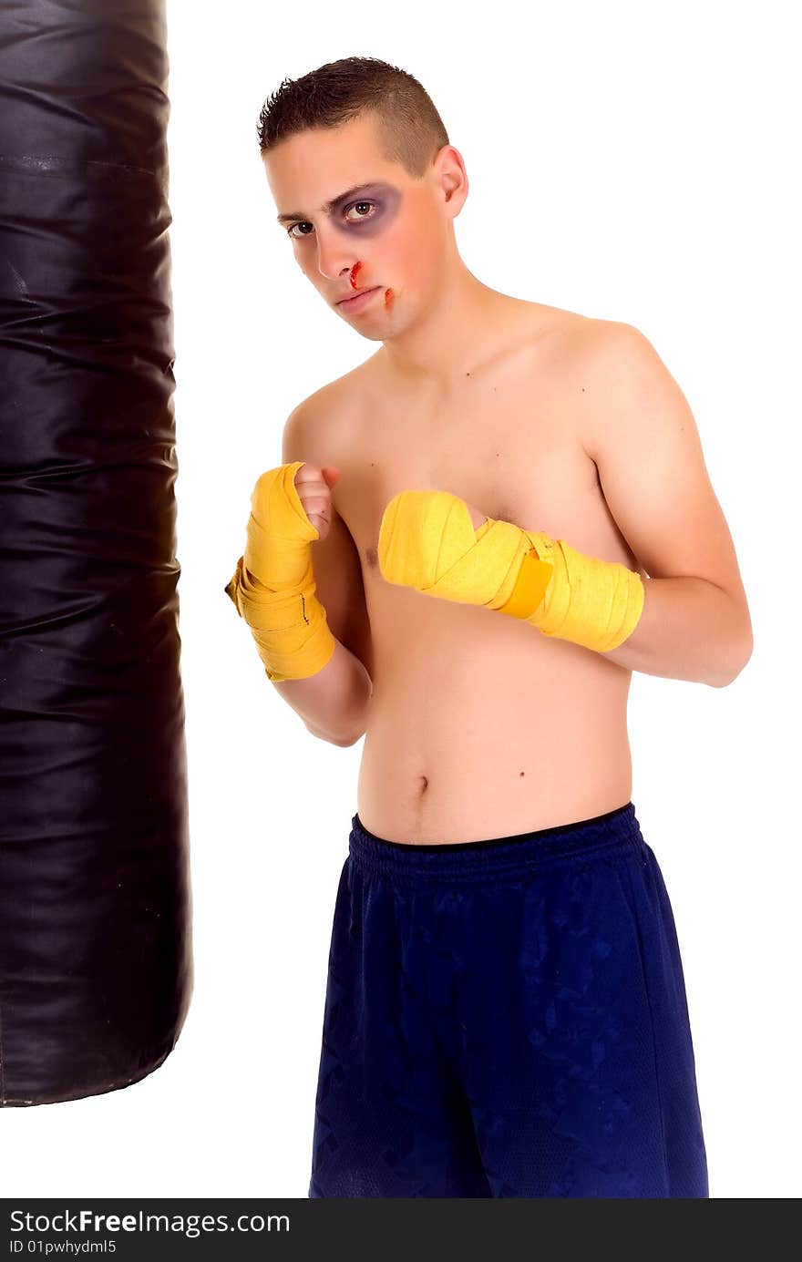 Youngster practicing the art of boxing with a punch-bag, studio shot on white background