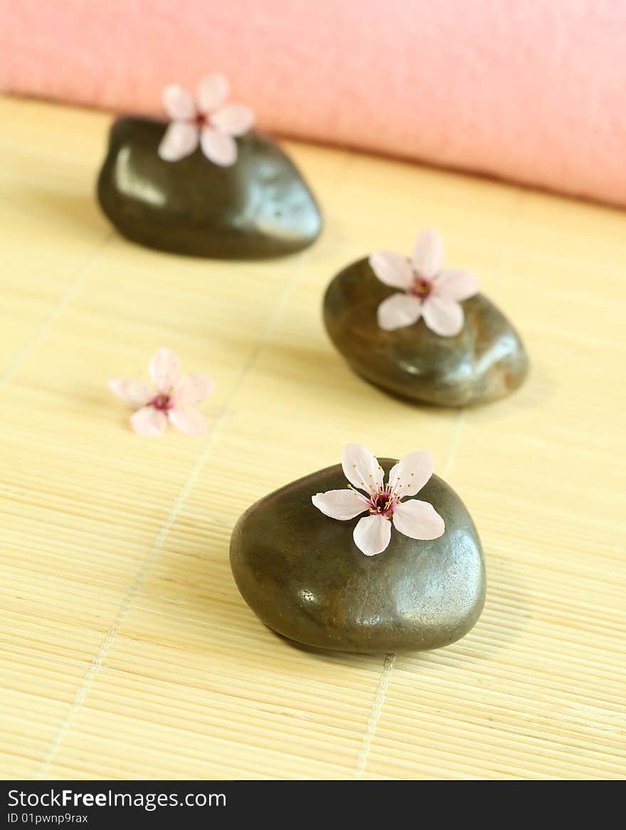 Spa composition of stones and pink flower