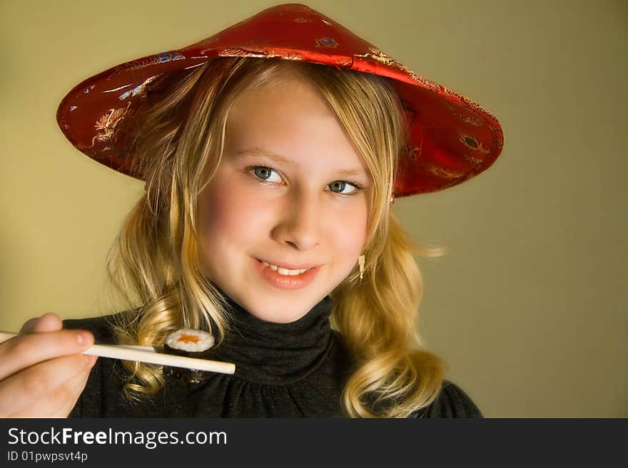 A smiling girl with chopsticks and sushi. A smiling girl with chopsticks and sushi