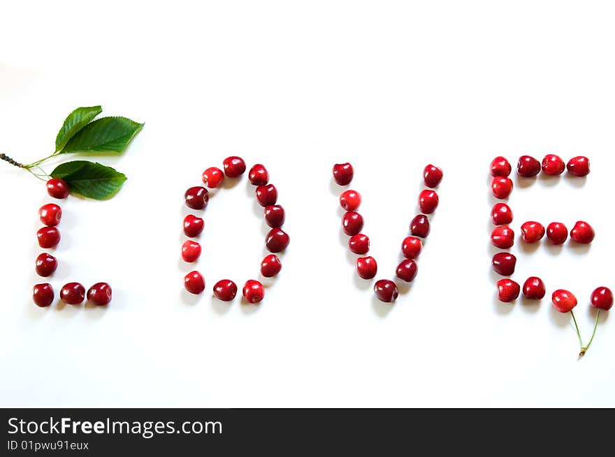 The the word love from sweet cherries which symbolize the love of two people