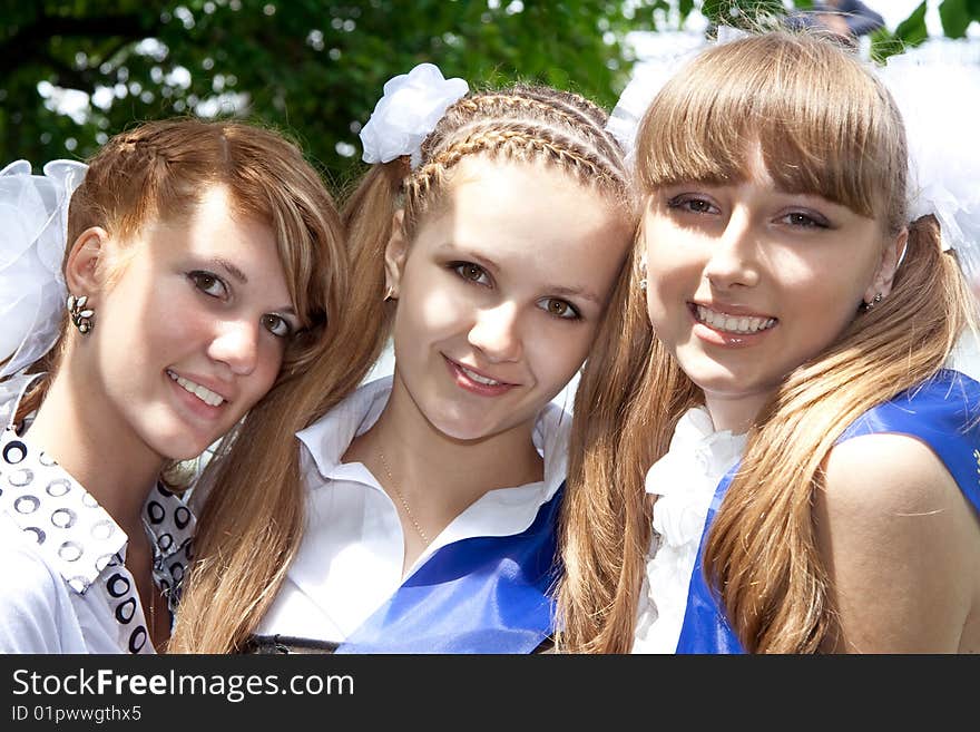 Three funny graduates posing outdoors