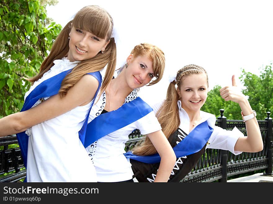 Three funny graduates posing outdoors