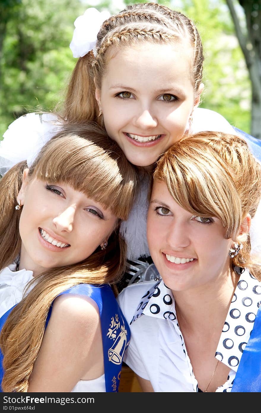 Three funny graduates posing outdoors