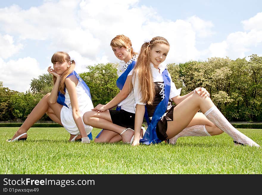 Three funny graduates posing outdoors