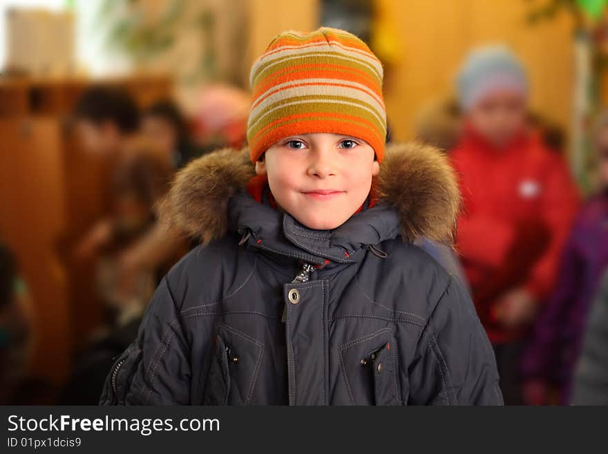 Dressed smiling boy in a room. Dressed smiling boy in a room