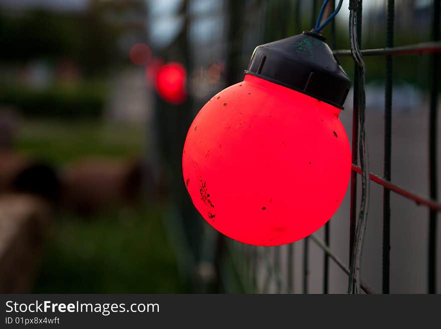 Red lantern on a mesh fence