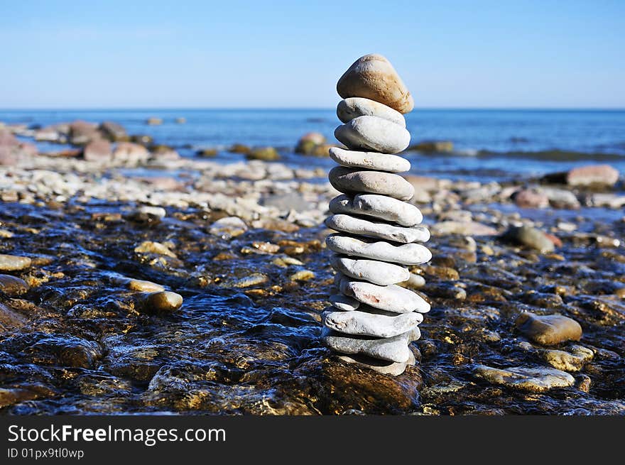 Stack of gravel among the stream on coast. Stack of gravel among the stream on coast