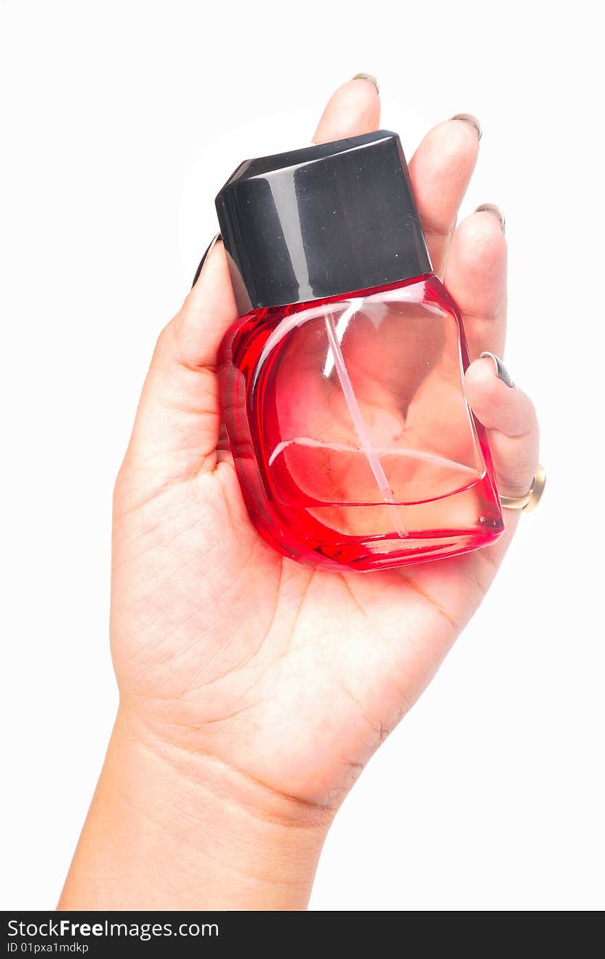 Red perfume bottle in female's hand.