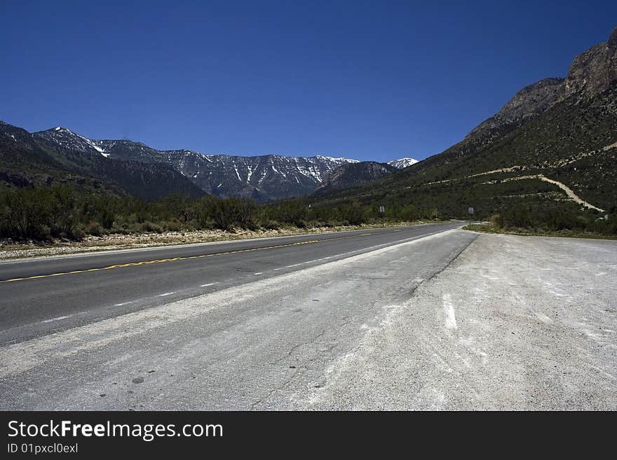 Empty Freeway With The Mountains On A Horizon