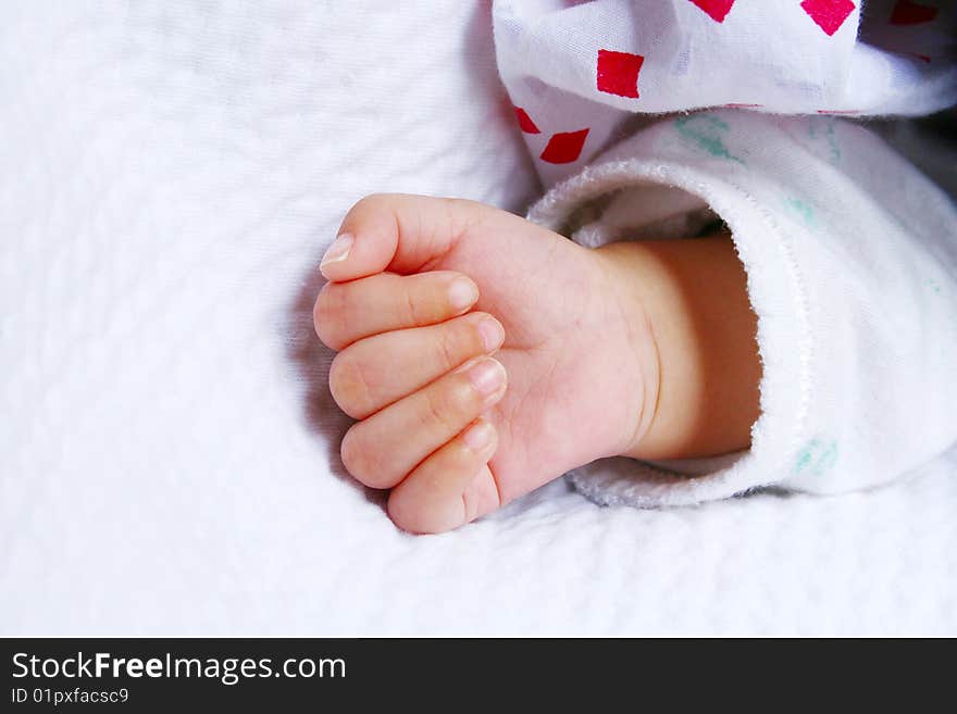 Hand of new born baby on a white blanket. Hand of new born baby on a white blanket