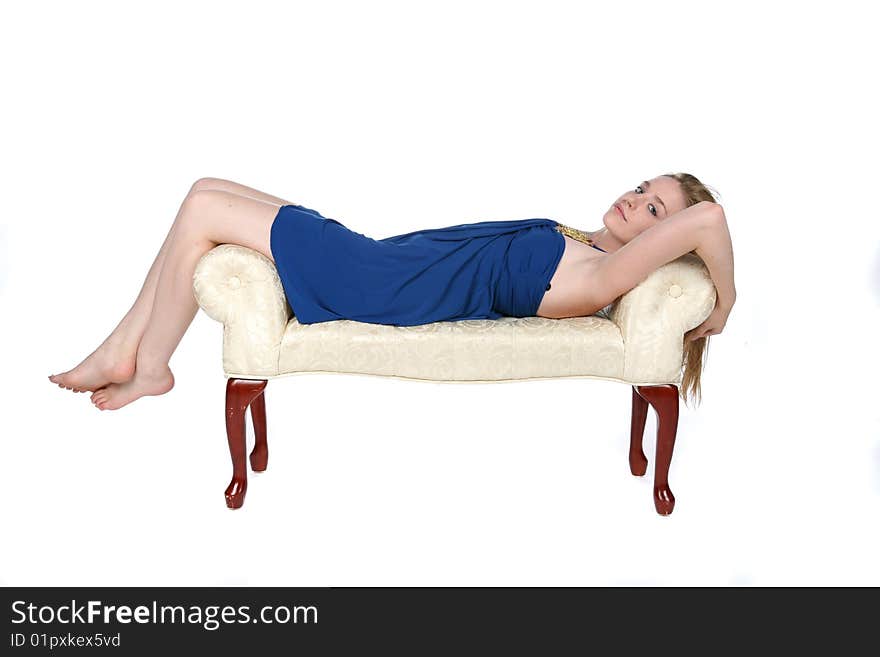 Beautiful Young Woman Reclining On White Bench